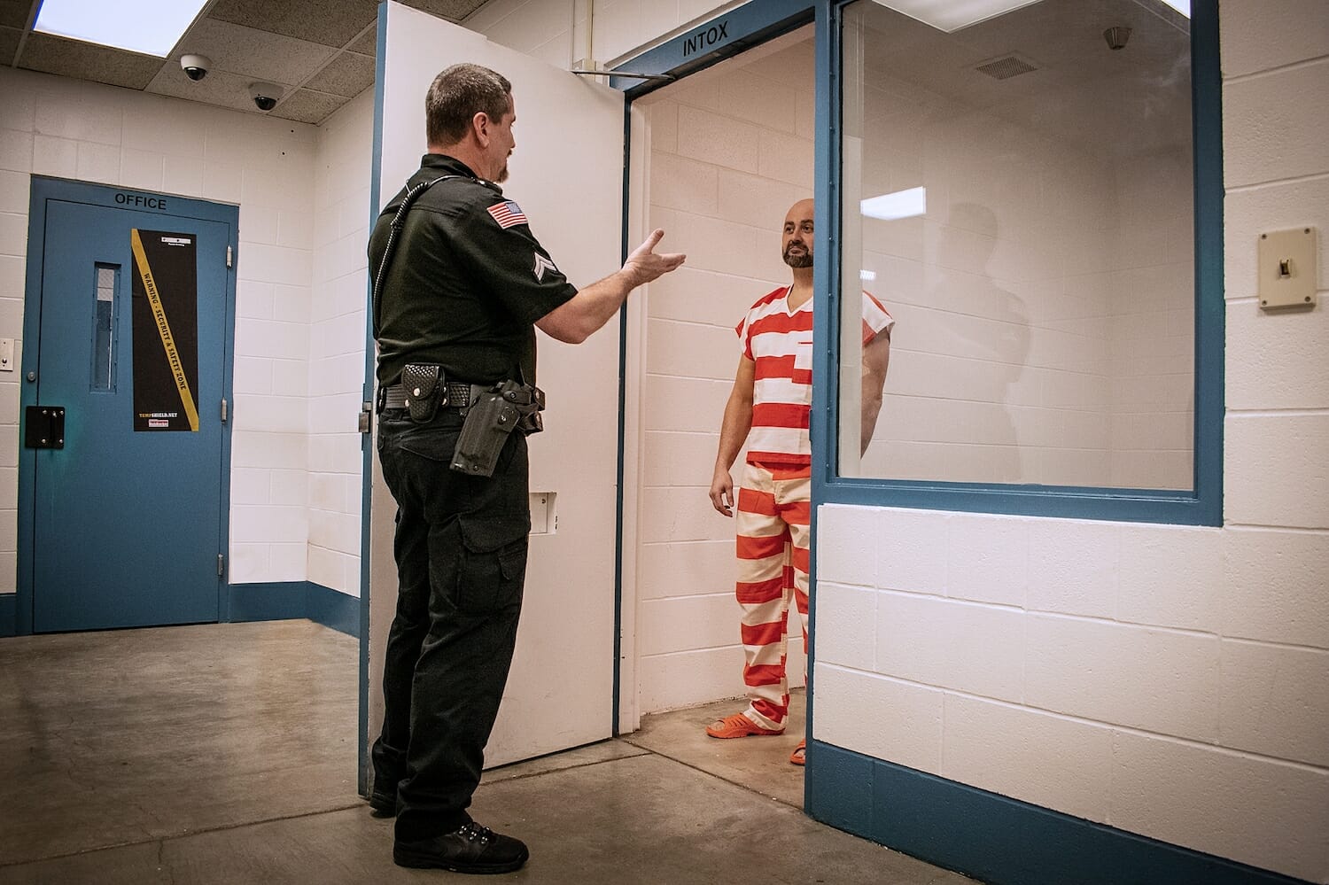 Corrections officer instructing jail inmate