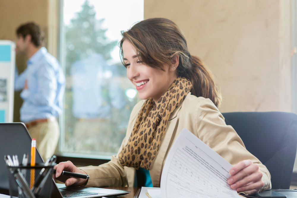 Woman going through paperwork in office